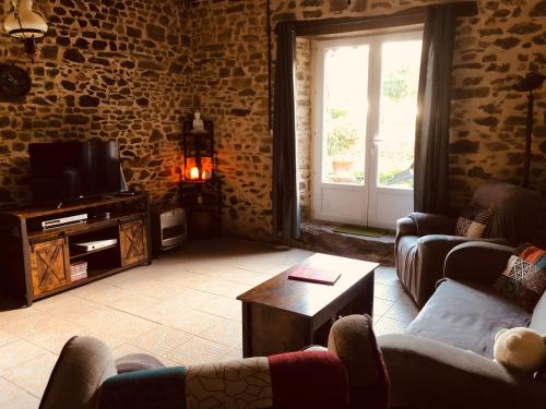a living room with two couches and a tv at Chambres d'Hôtes Bastia et Bonifacio in Retiers