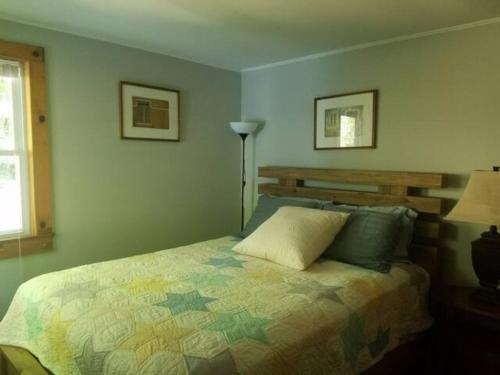 sypialnia z łóżkiem i lampką w obiekcie Tory Hill w mieście Hillsdale