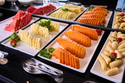 a buffet with many different types of food on plates at Foz Plaza Hotel in Foz do Iguaçu
