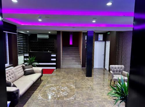 a lobby with a couch and a purple ceiling at Hotel Casablanca in Goražde