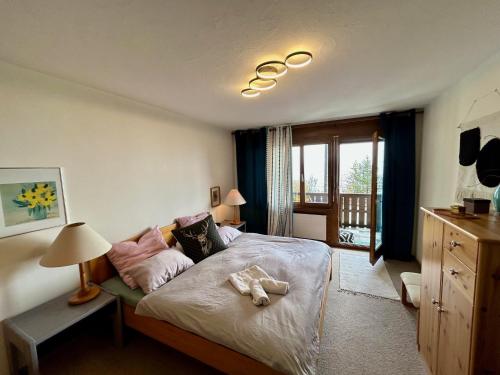 a bedroom with a bed and a dresser in it at Charming Apartment in Laax in Laax