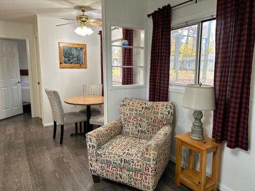 uma sala de estar com uma cadeira e uma mesa em Hidden Haven Cottages em Lake City