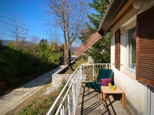 a porch with a chair and a table on a house at Leunovo Adventure Villa in Leunovo