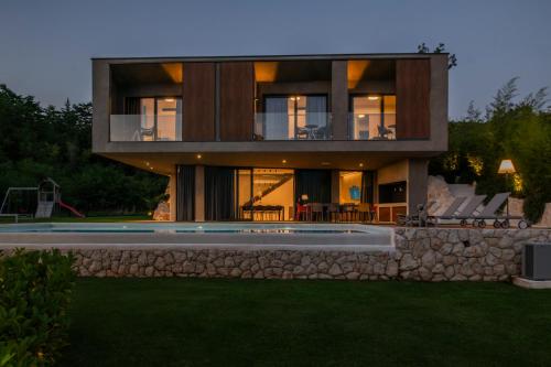 a house with a swimming pool in the backyard at ARGENTO RESIDENCE in Zagvozd