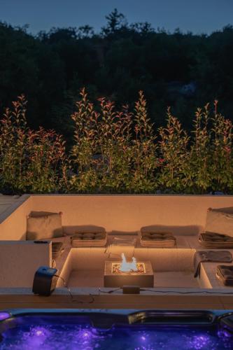 a table with a candle on top of a pool at ARGENTO RESIDENCE in Zagvozd