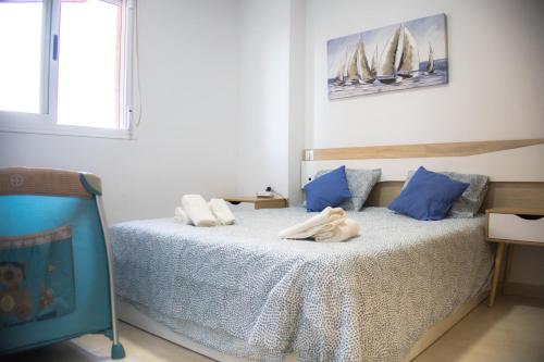 a bedroom with a bed with two towels on it at Beachfront Family Retreat, Marina d'Or in Oropesa del Mar