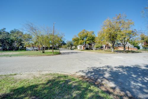 an empty street in a residential neighborhood with trees at Pet-Friendly Brady Vacation Home Near Wineries! in Brady