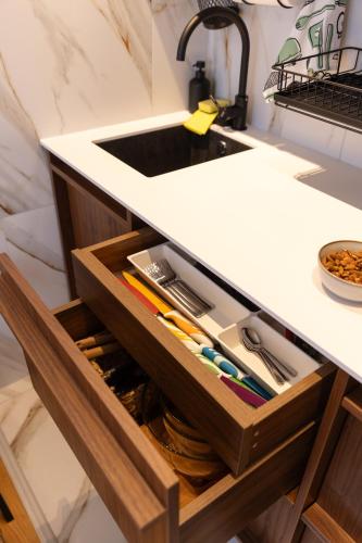 a kitchen counter with a sink and a drawer at Glečer Kop, Cozy design apartment A5, FREE Parking Garage in Kopaonik