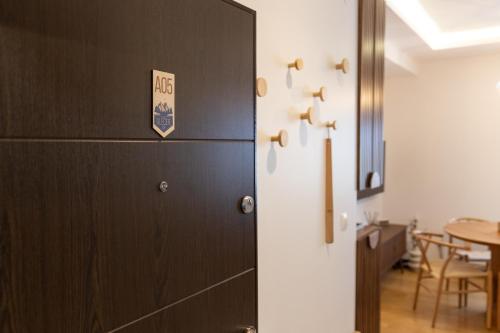 a door to a dining room with a table at Glečer Kop, Cozy design apartment A5 in Kopaonik
