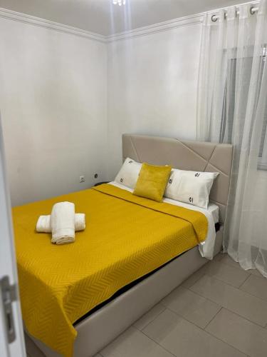 Cette chambre comprend un lit avec des draps jaunes et des oreillers blancs. dans l'établissement Família Joaquim, à Lisbonne