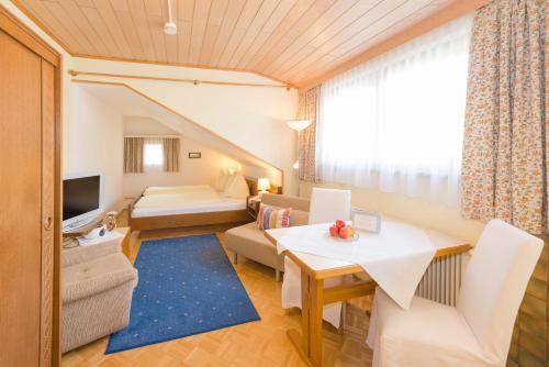 a living room with a couch and a table at Landhaus Tritscher in Schladming