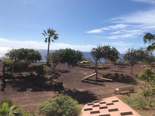 a park with trees and the ocean in the background at La casita de Mon - Radazul in Radazul