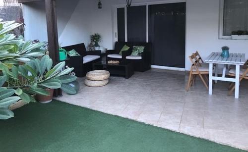 a living room with couches and a green rug at La casita de Mon - Radazul in Radazul