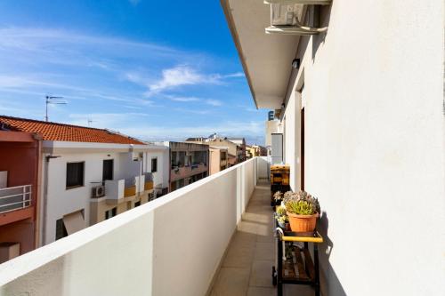 a balcony of a building with plants on it at Secret Paradise & SPA Rooftop in Quartu SantʼElena