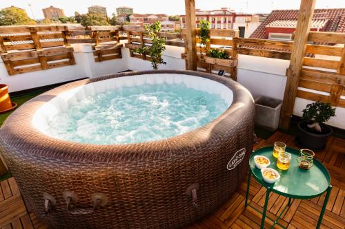 a large wicker tub sitting on top of a balcony at Secret Paradise & SPA Rooftop in Quartu SantʼElena
