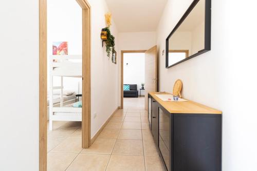 a kitchen with a sink and a mirror at Secret Paradise & SPA Rooftop in Quartu SantʼElena