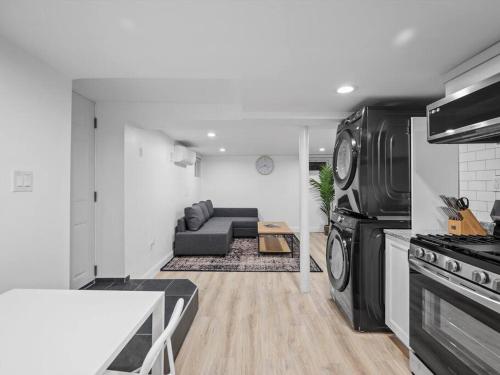 a living room with a couch and a stove at Shadyside, Pittsburgh, Modern and Quiet 1 Bedroom Unit1 with Free Parking in Pittsburgh