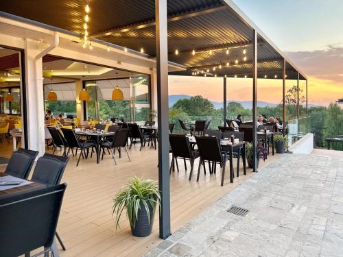a restaurant with tables and chairs on a patio at AJ Apartment 2, Santa Marina Holiday Village, Sozopol in Sozopol