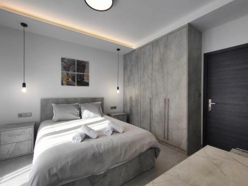 a bedroom with a large bed with towels on it at Meteora Scenic Loft in Kalabaka