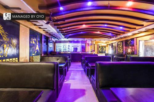 a train car with black seats and purple lighting at Townhouse 1295 Alps Residency in Puducherry