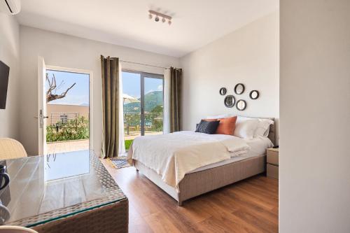 a bedroom with a bed and a large window at Casa Collection in Tivat