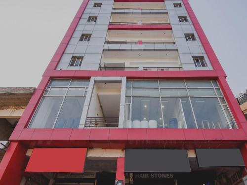 a tall building with a red trim at HC Sohana inn in Sohāna