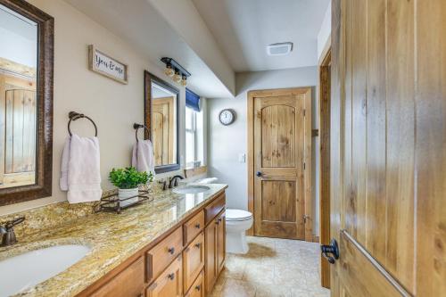 a bathroom with a sink and a toilet and a mirror at Angel Fire Cabin with Deck 3 Mi to Ski Lifts! in Angel Fire