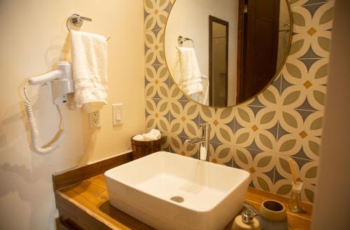 a bathroom with a white sink and a mirror at Estancia 101 in La Paz