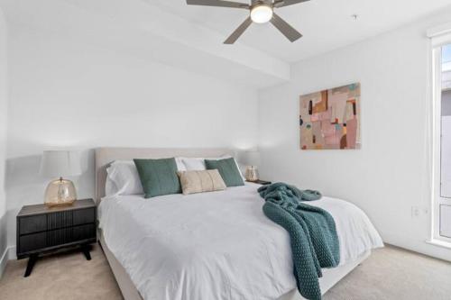a white bedroom with a bed with a ceiling fan at Ruby Tide - Two Floor Airy 2BR Marina Side Exclusive Amenities in Los Angeles