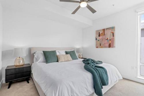 a white bedroom with a bed with a ceiling fan at Luxurious 2-Bedroom 2-Bath Unit with Marina Views in Los Angeles