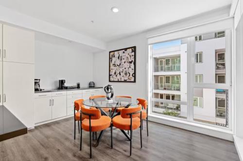a kitchen and dining room with a table and chairs at Ruby Tide - Two Floor Airy 2BR Marina Side Exclusive Amenities in Los Angeles