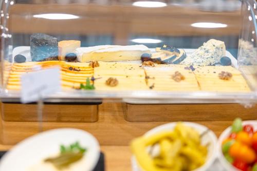 a display of cheese and other foods on a table at Hotel Stainzerhof in Stainz