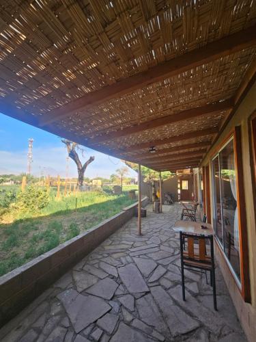 a patio with a table and a bench on it at Hostal Casa los Duendes in San Pedro de Atacama