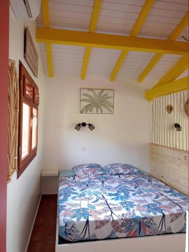 a bedroom with a bed in a room at La Mare à Cuja in Sainte-Rose