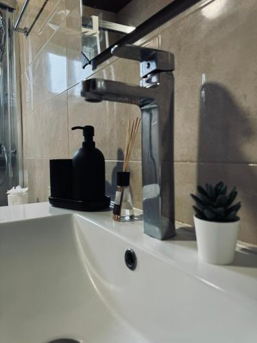 a bathroom sink with a black faucet on a counter at Avenida 52 B in Los Llanos de Aridane