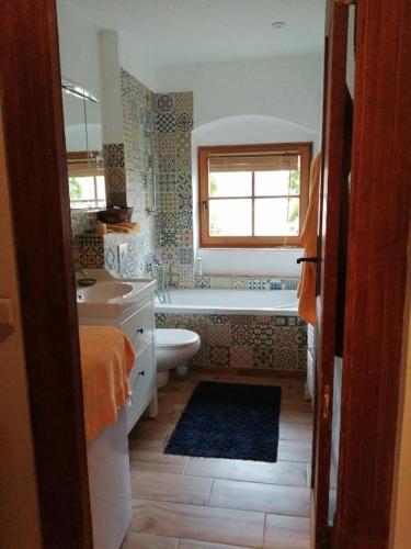 a bathroom with a tub and a toilet and a sink at Haus Schmeile in Magdeburg