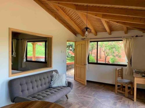 - un salon avec un canapé et une fenêtre dans l'établissement Brisas de Sol, à Pátzcuaro