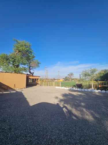 a shadow of a horse on a gravel road at Hostal Casa los Duendes in San Pedro de Atacama