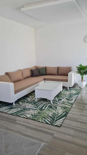 a living room with a couch and a rug at Raya in Midoun