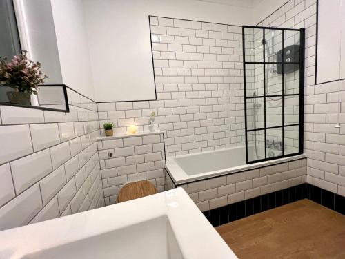 a white bathroom with a tub and a sink at Luxury Victorian House Sleeps 6 - 11 Guests JLR, Trades, Relocations & Hs2 Welcome Wheelchair Accessible Home FREE Faster WIFI & PARKING in Coventry