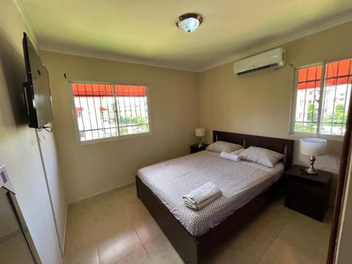 a bedroom with a bed with two towels on it at Stylish Stay Ciudad Juan Bosch in Los Paredones