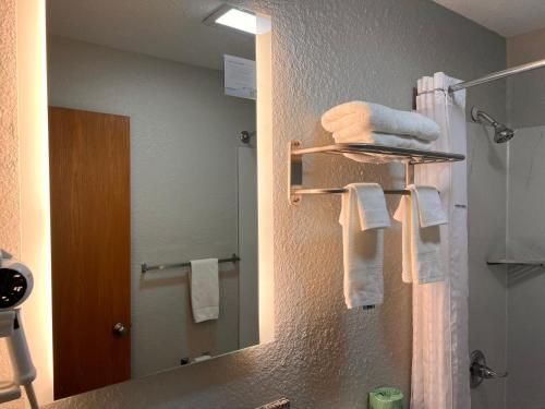 a bathroom with a sink and a mirror and towels at Super 8 by Wyndham Elizabethtown in Elizabethtown