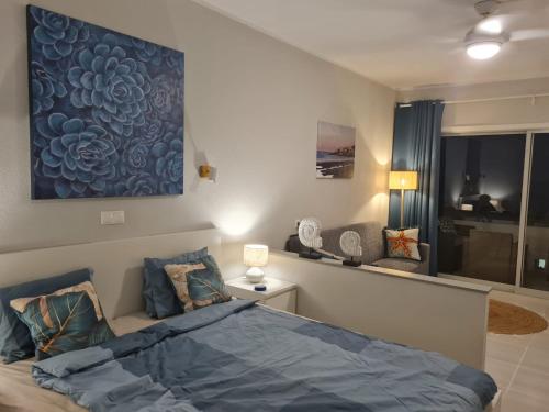 a bedroom with a bed and a large painting on the wall at Apartment Casa M in Morro Jable in Morro del Jable
