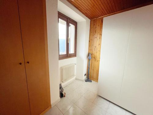 un pasillo vacío con una ventana y una puerta en Ca al Borgo - Lago di Como, en Faggeto Lario 