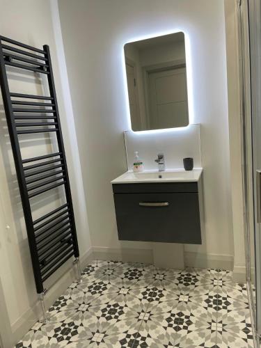 a bathroom with a sink and a mirror at Salt Life Portstewart in Portstewart