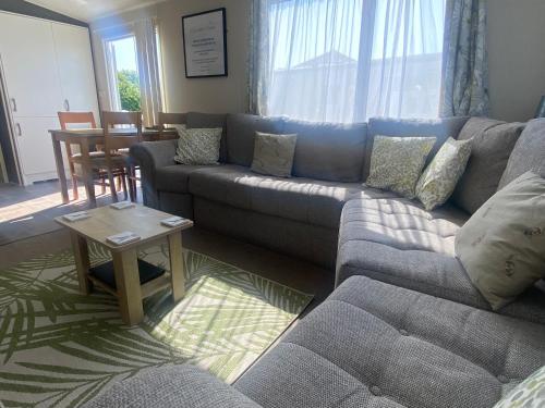a living room with a couch and a table at Hot tub. Countryside. Coast. 5* Patrington Haven Leisure Park, East Yorkshire in Patrington