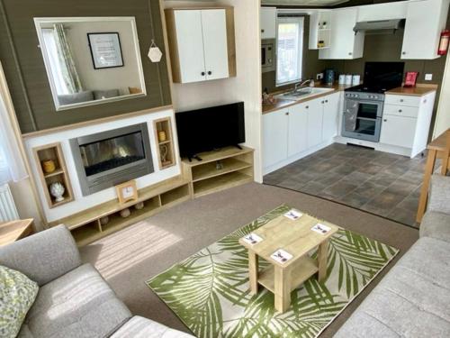 a living room with a couch and a table and a kitchen at Hot tub. Countryside. Coast. 5* Patrington Haven Leisure Park, East Yorkshire in Patrington