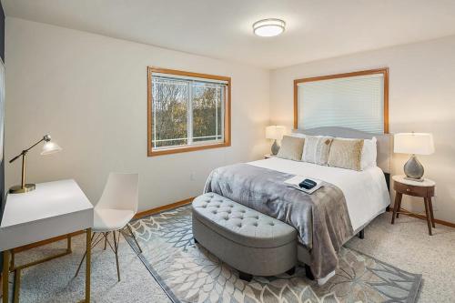 a bedroom with a bed and a table and a desk at Cozy Cloverdale BY Betterstay in Seattle