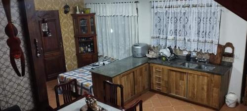 a kitchen with a sink and a counter top at Casa na Floresta em Campos do Jordao in Campos do Jordão