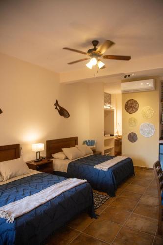 a bedroom with two beds and a ceiling fan at Estancia 104 in La Paz